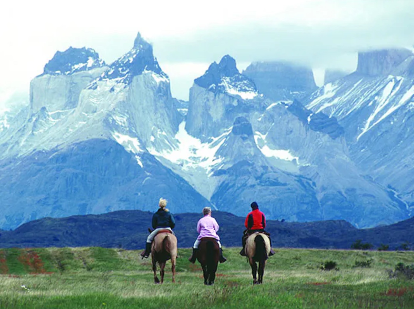 Horseback riders with Torres del Paine mountains in background
